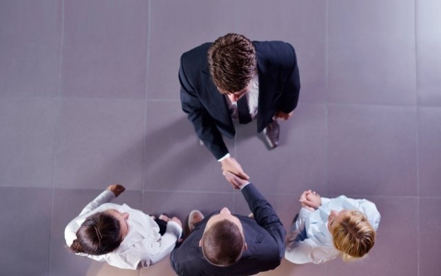 businessmen shaking hands with each after making a deal