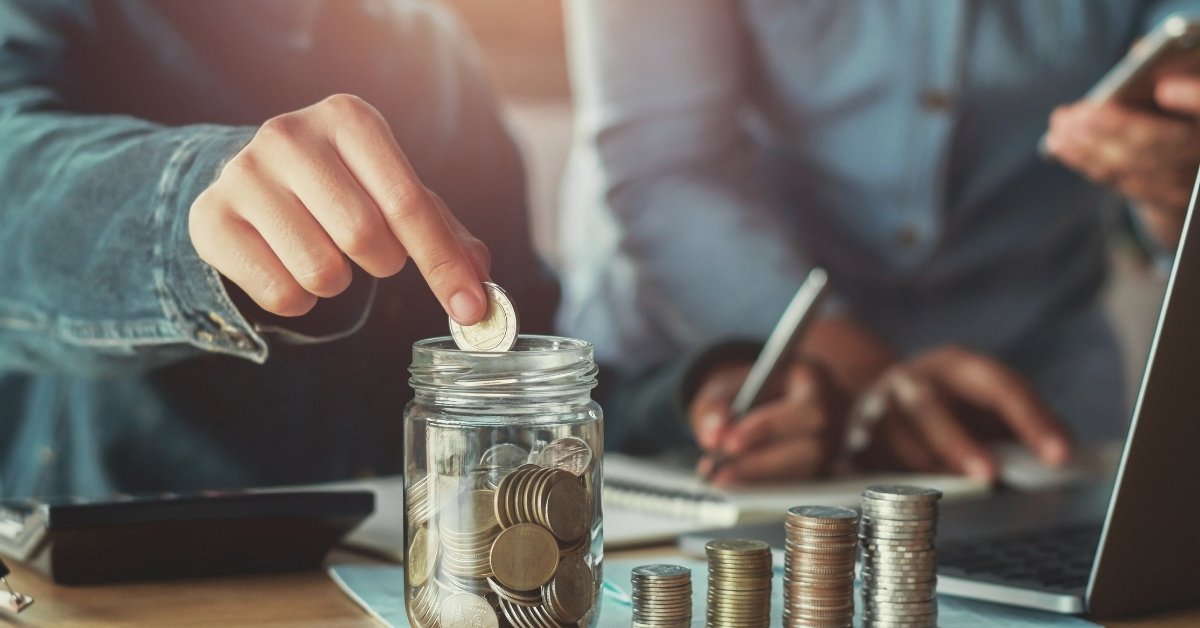 two people counting their money and keeping its record in a notebook